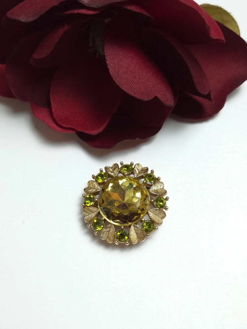 Vintage Avon 'Sun Brilliance' Green Crystal Gold Tone Brooch Pendant 1970s Avon